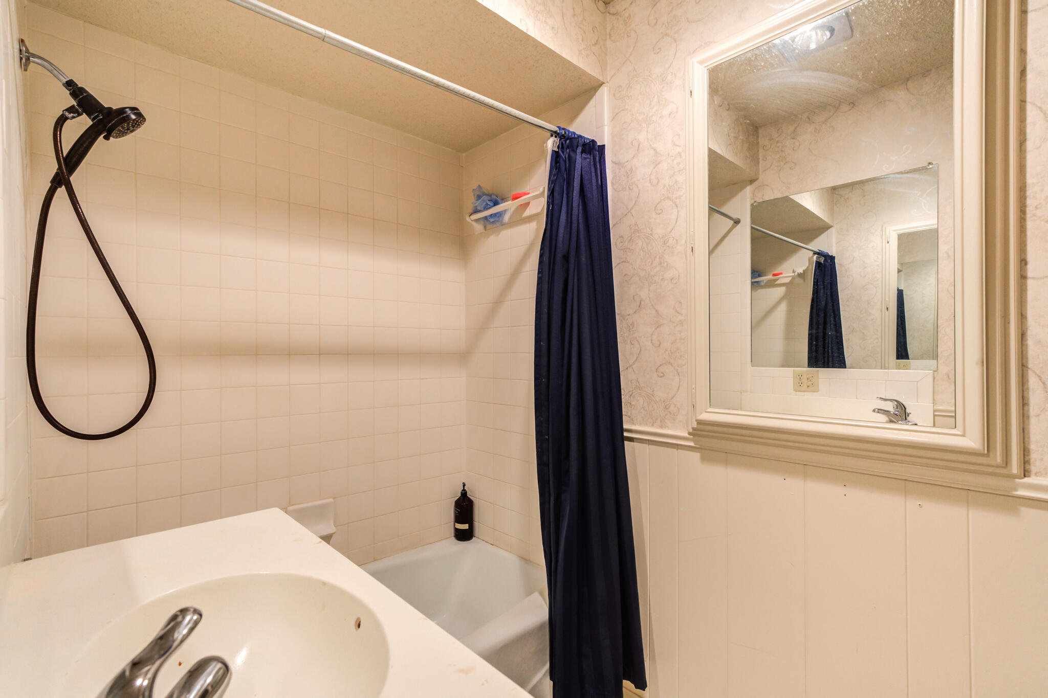 4629 88th Street Lubbock, TX 79424 - Photo 47 of 60 a bathroom with a tub a sink and a mirror