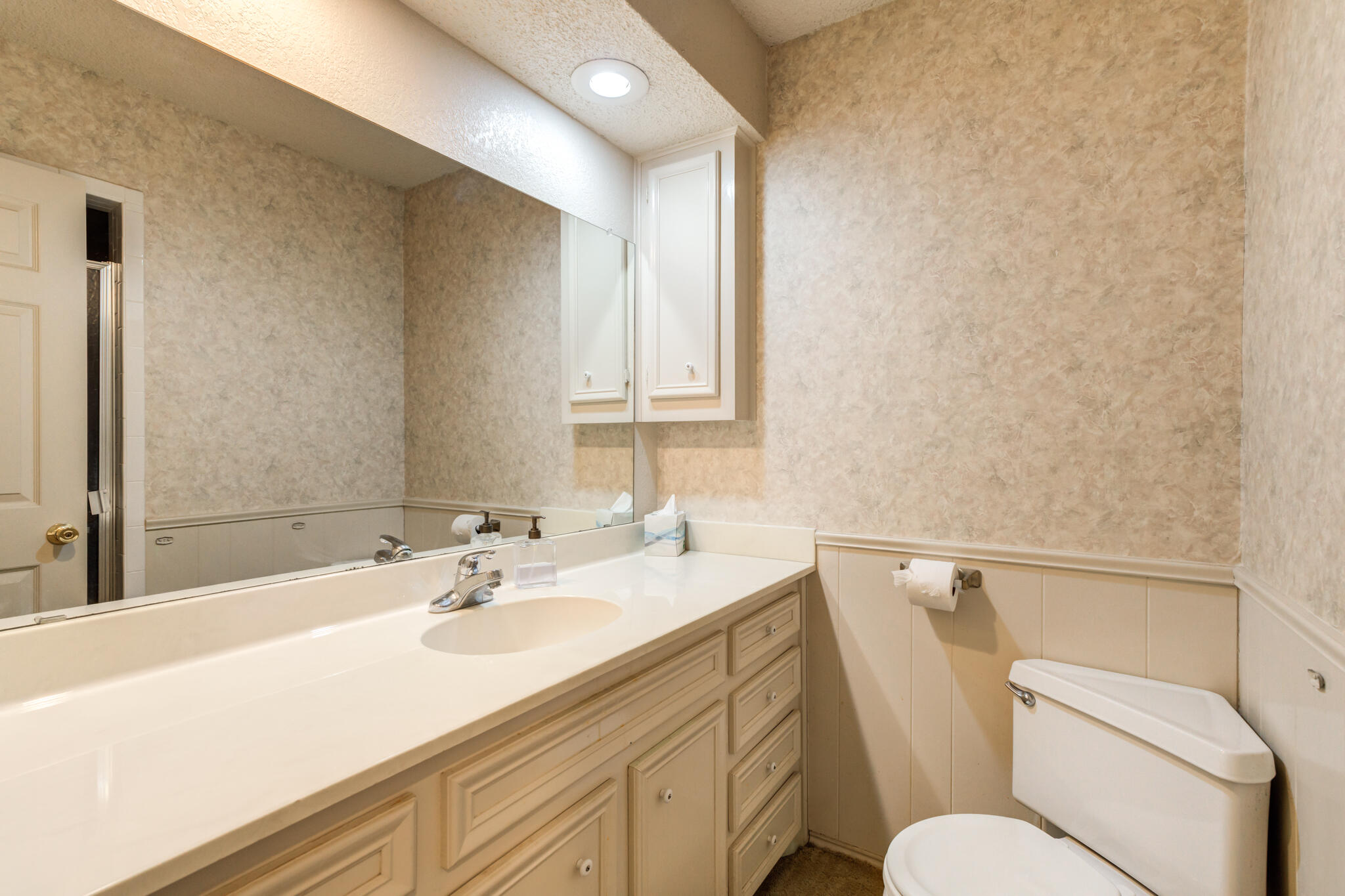4629 88th Street Lubbock, TX 79424 - Photo 50 of 60 a bathroom with a sink toilet vanity and tub