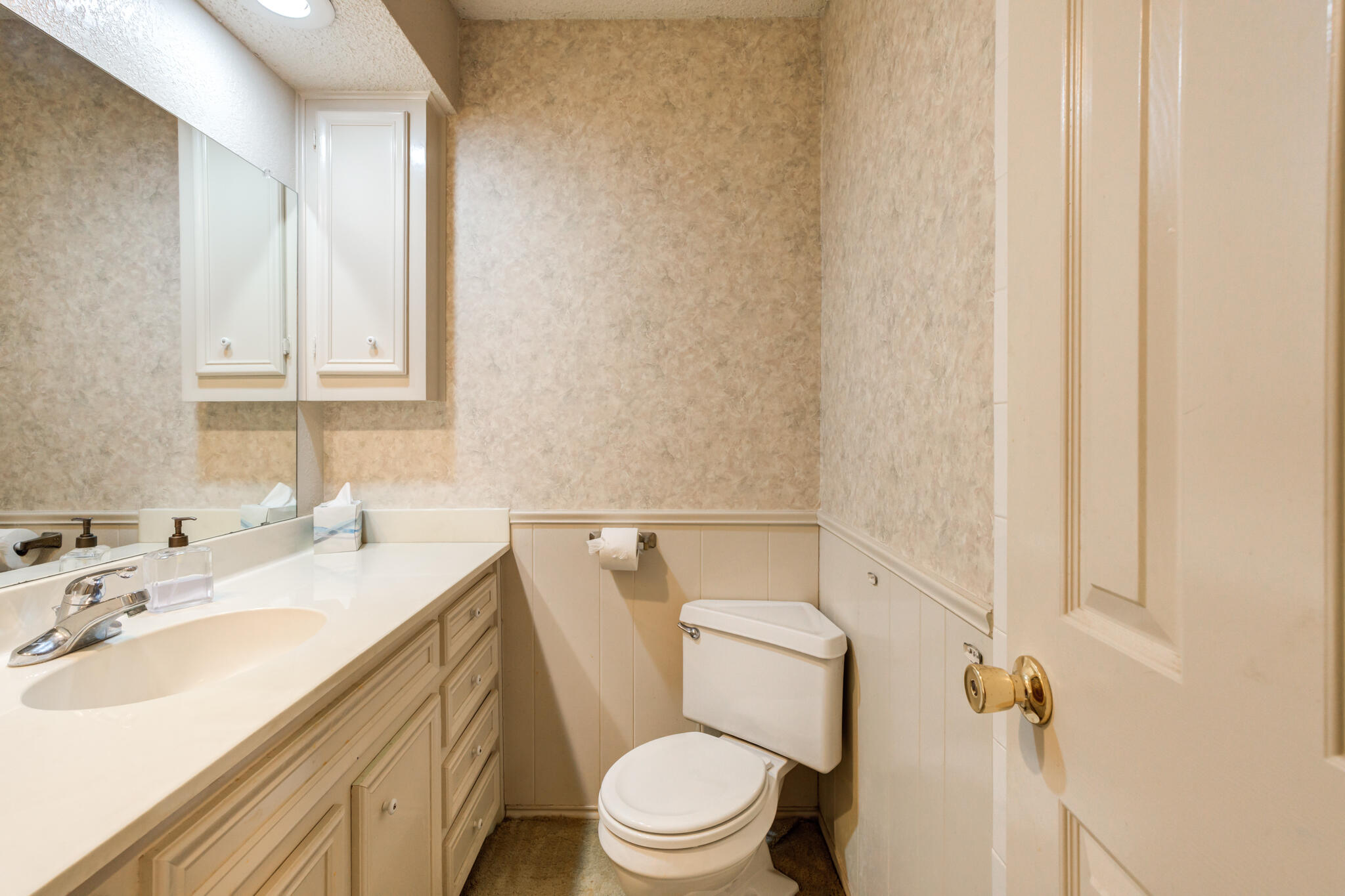 4629 88th Street Lubbock, TX 79424 - Photo 51 of 60 a bathroom with a granite countertop toilet sink and mirror