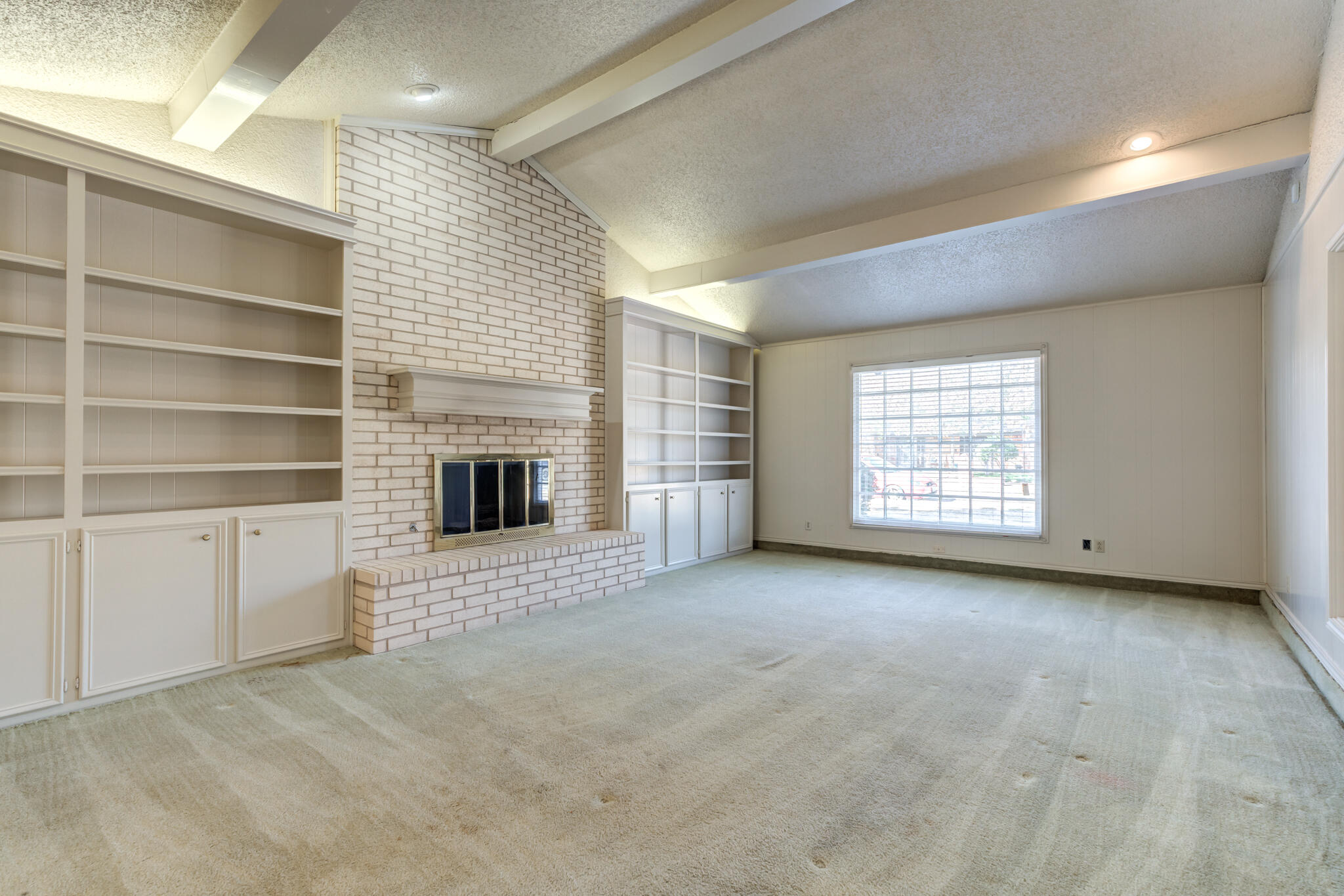 4629 88th Street Lubbock, TX 79424 - Photo 8 of 60 a view of an empty room with a fireplace and a window
