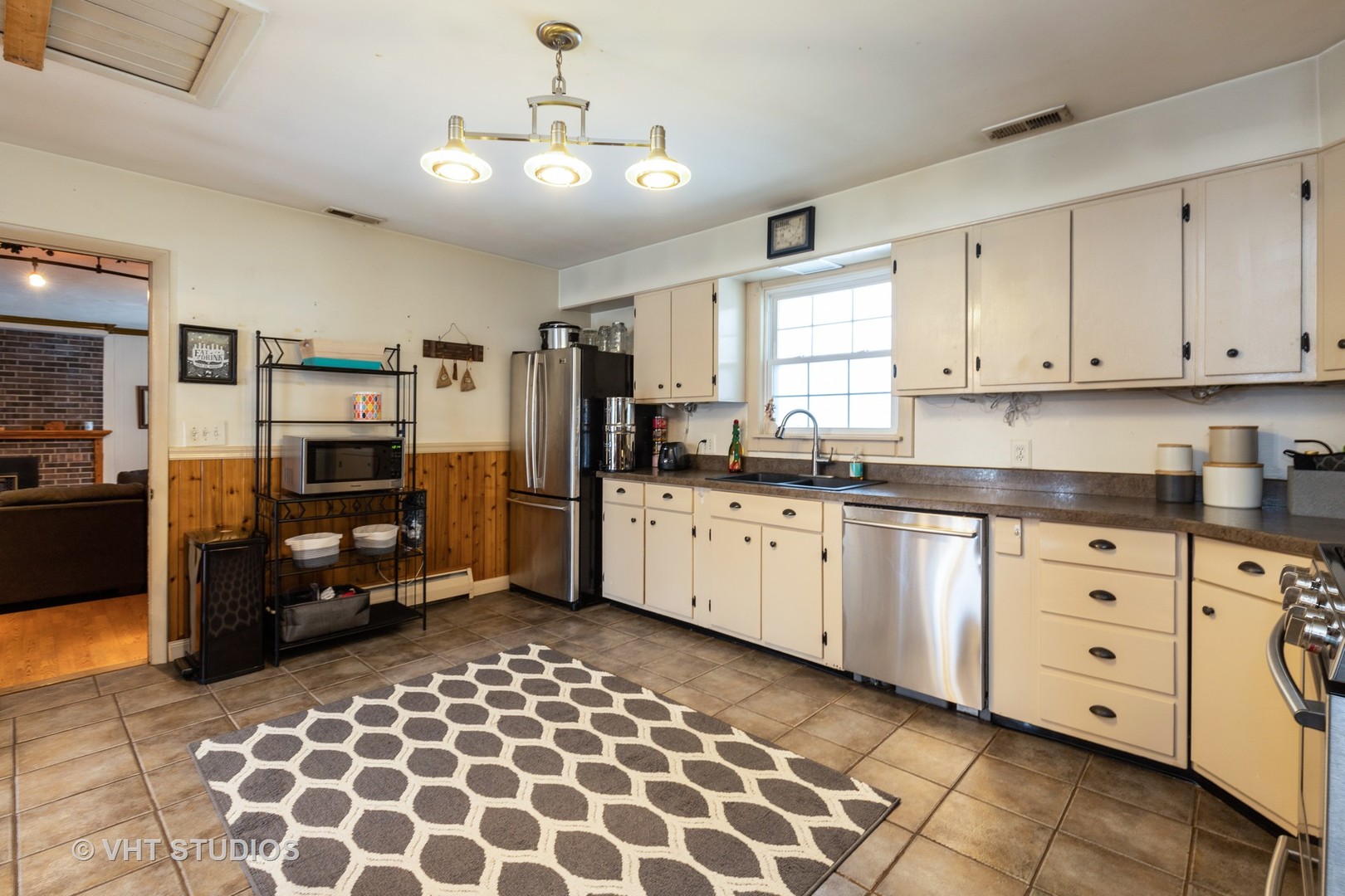 26649 West Wilmot Road Antioch, IL 60002 - Photo 3 of 13 a kitchen with granite countertop a refrigerator and cabinets