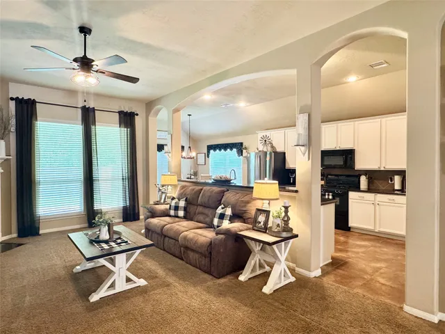 a view of a room with furniture and a chandelier