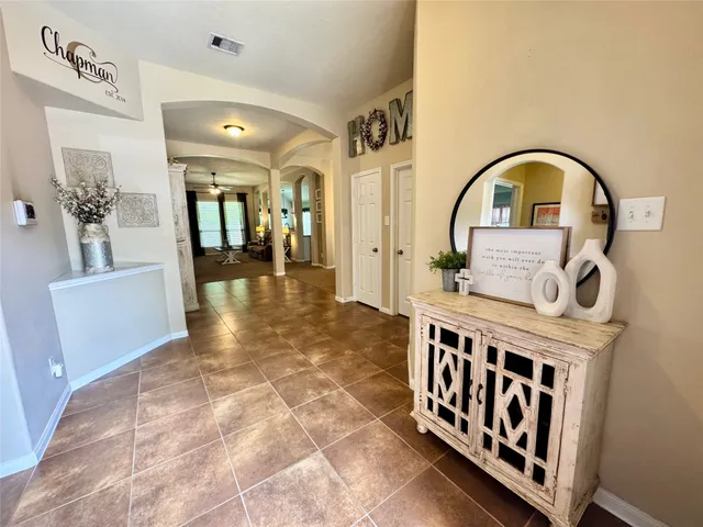 a view of a hallway with wooden shelves