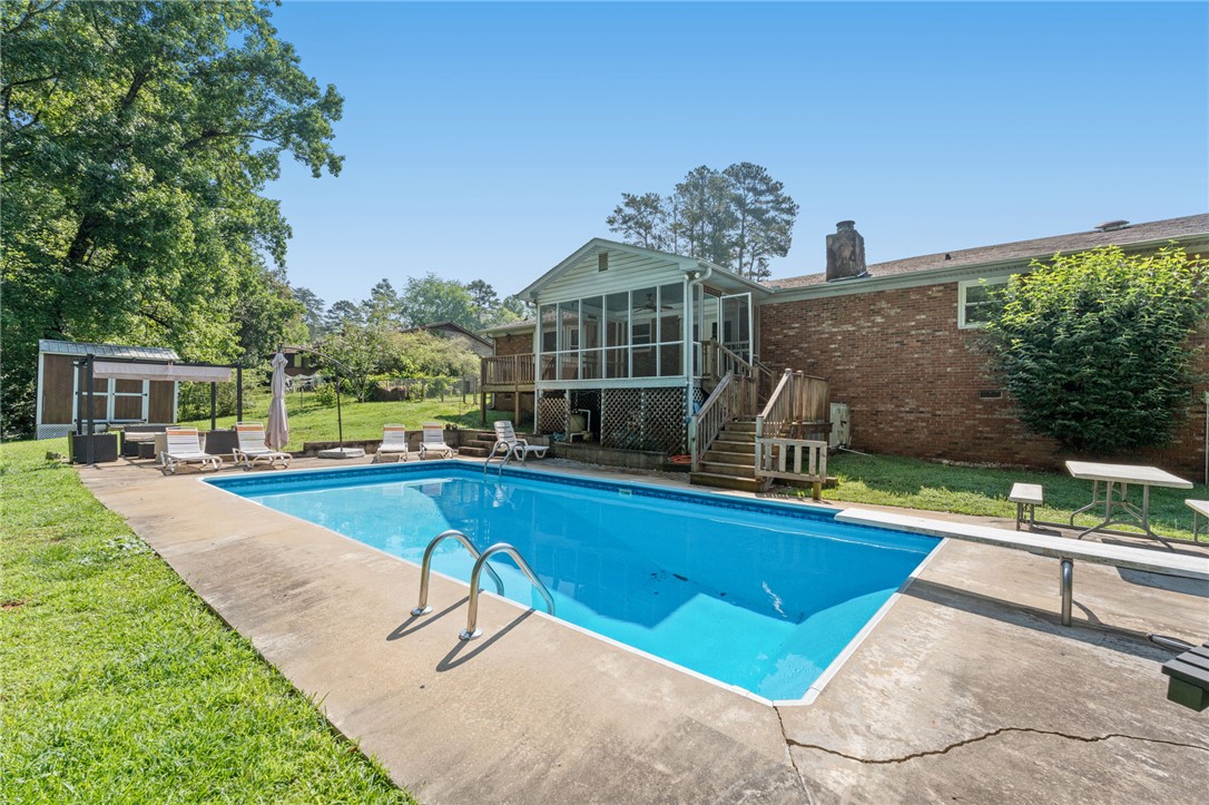 200 Echo Circle Easley, SC 29642 - Photo 27 of 35 A spacious backyard oasis with a sparkling in-ground pool and an elevated screened porch.