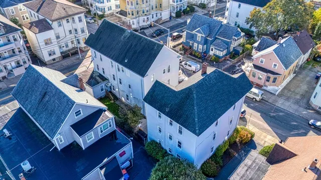 an aerial view of residential houses with wooden fence