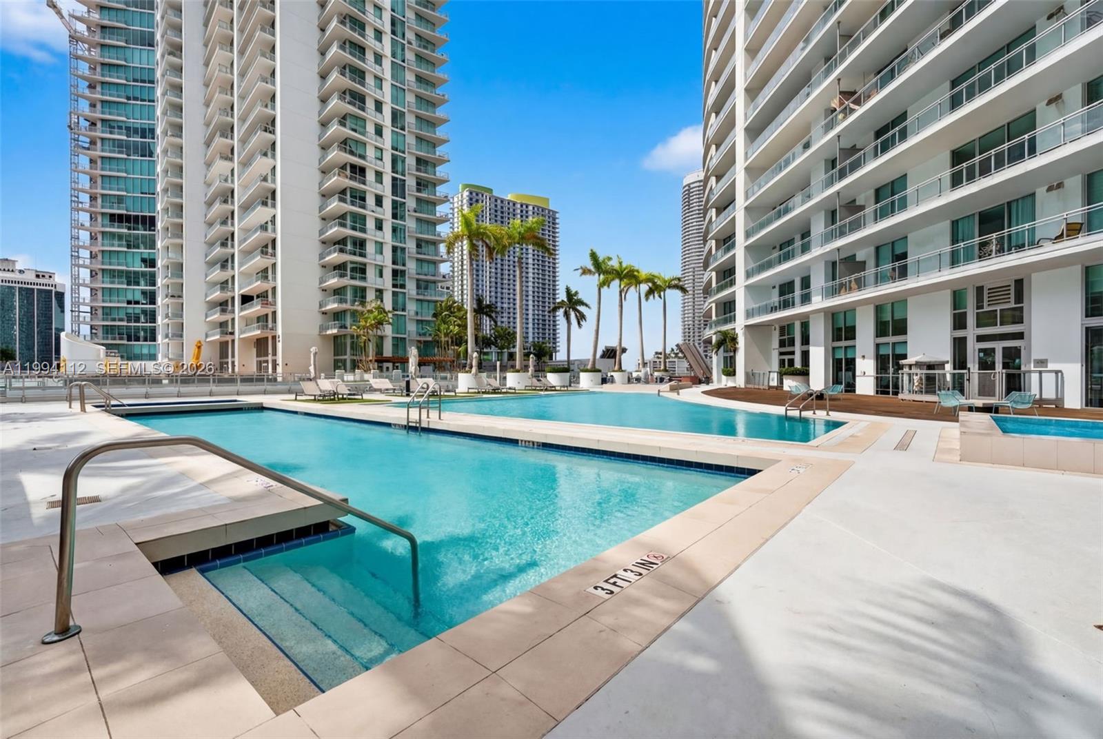 90 Southwest 3rd Street, Unit 1105 Miami, FL 33130 - Photo 2 of 11 a swimming pool with outdoor seating and yard