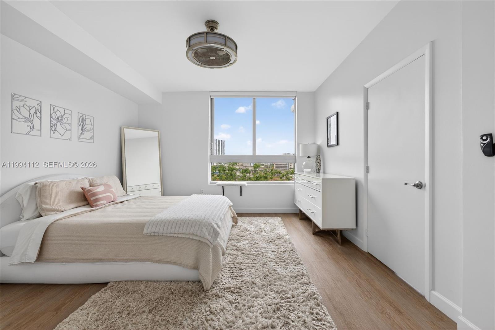 90 Southwest 3rd Street, Unit 1105 Miami, FL 33130 - Photo 4 of 11 a room with a bed furniture and a large window