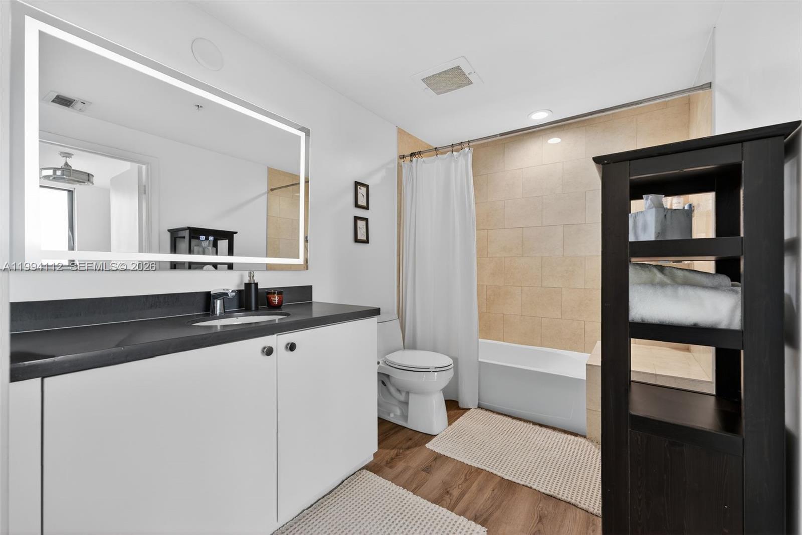 90 Southwest 3rd Street, Unit 1105 Miami, FL 33130 - Photo 9 of 11 a bathroom with a sink a toilet and shower