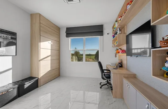 a living room with furniture a flat screen tv and a large window