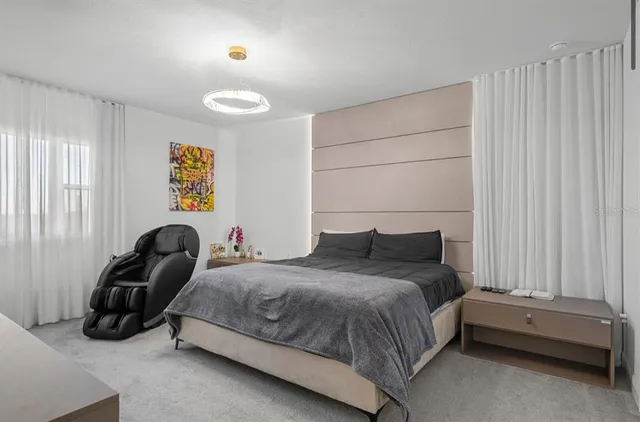 a bedroom with a bed and flat screen tv