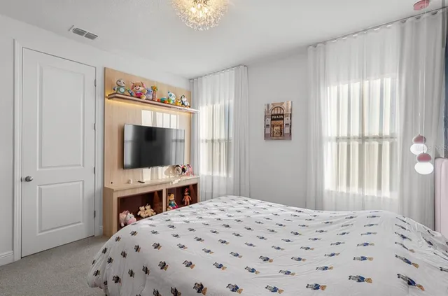 a bedroom with a bed and a dresser