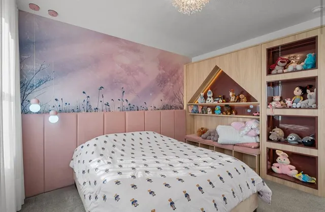 a bedroom with a bed and a flat tv screen on dresser