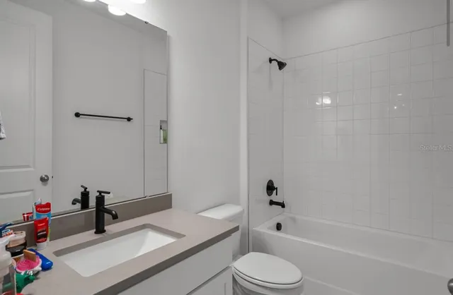 an aerial view of house with a garden