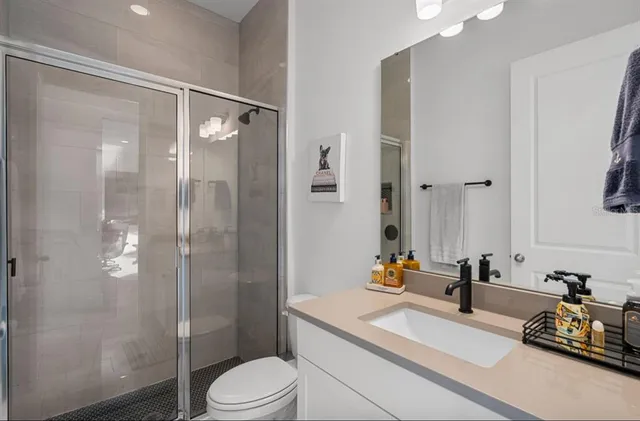 a bathroom with a sink toilet and shower