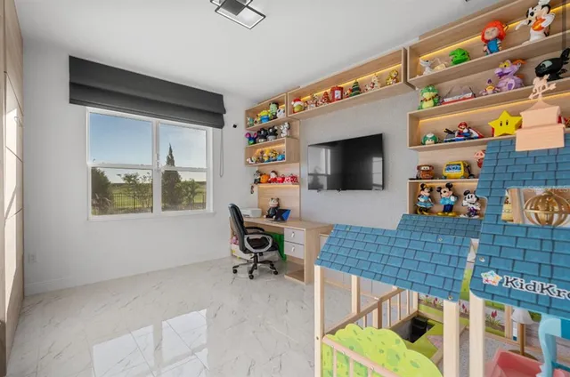 a work room with furniture and a flat screen tv