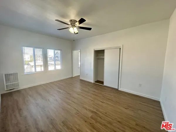 a kitchen with white cabinets and sink