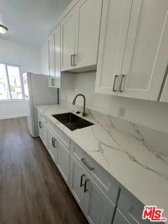 a stove top oven sitting inside of a kitchen