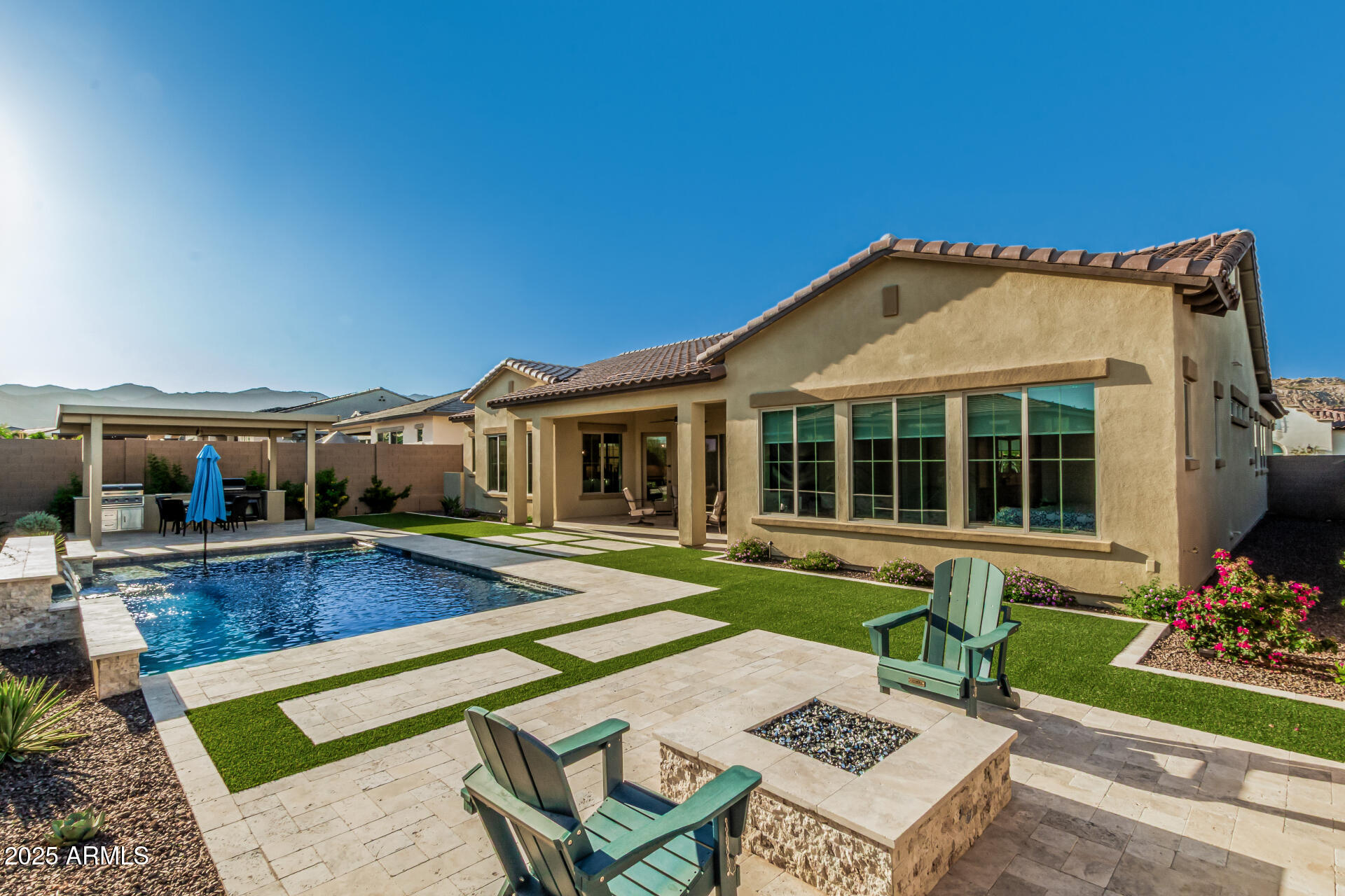 a front view of a house with swimming pool having outdoor seating
