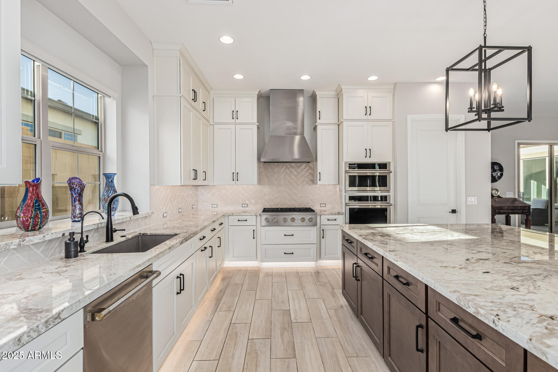 20709 West Rattler Road Buckeye, AZ 85396 - Photo 14 of 66 a large kitchen with stainless steel appliances granite countertop a sink stove and refrigerator