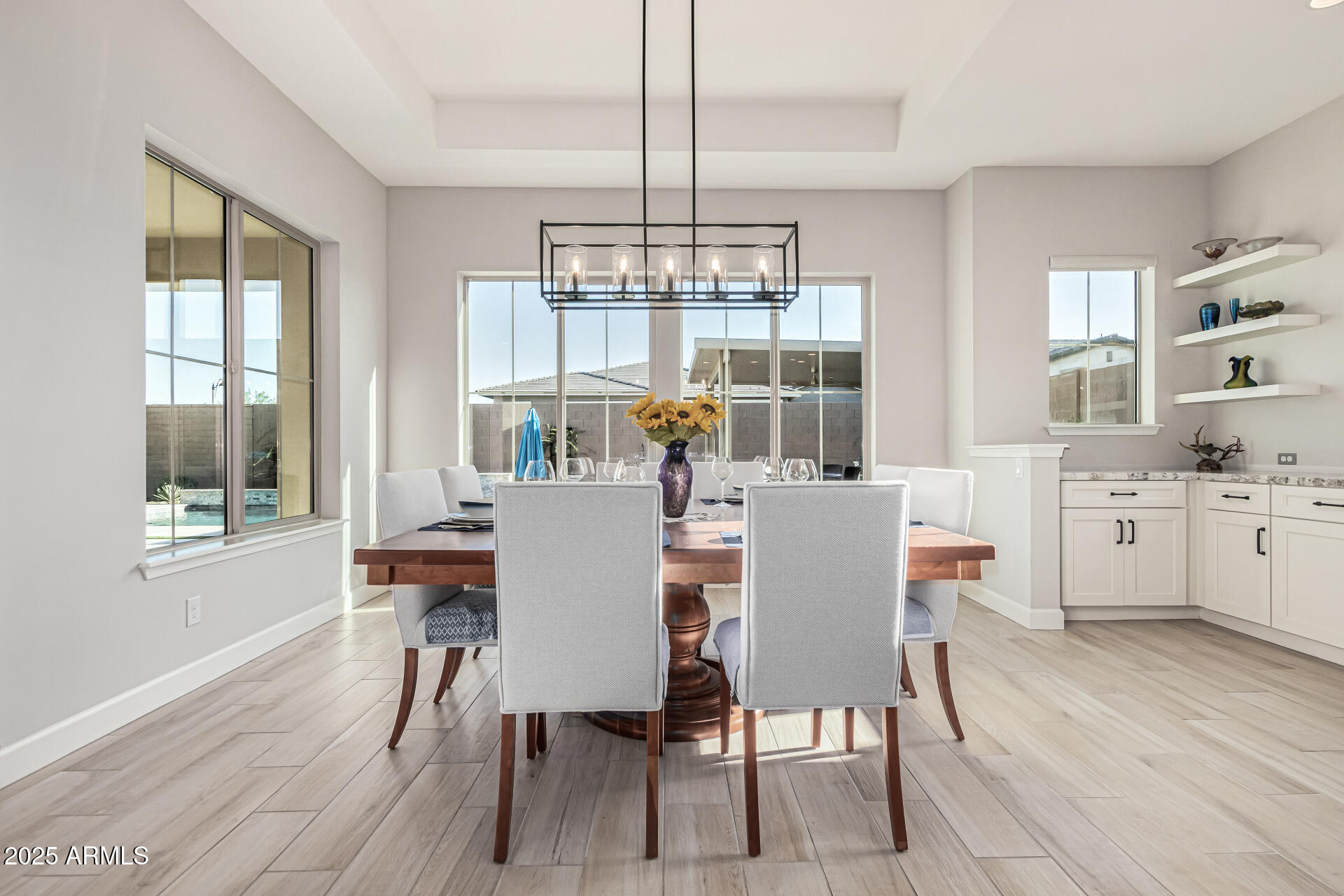 20709 West Rattler Road Buckeye, AZ 85396 - Photo 19 of 66 a dining room with furniture a chandelier and wooden floor