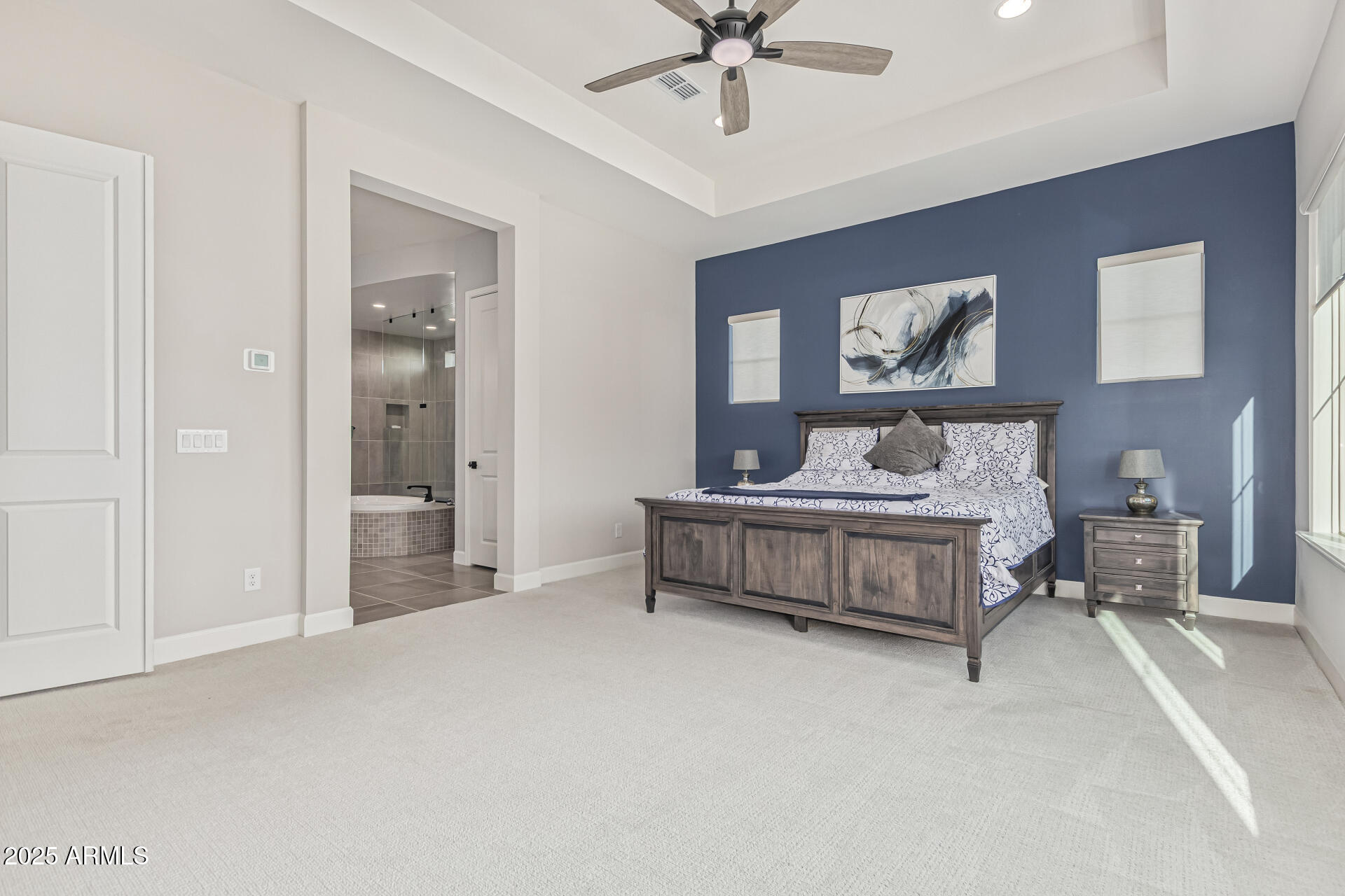 20709 West Rattler Road Buckeye, AZ 85396 - Photo 22 of 66 a spacious bedroom with a bed and a chandelier