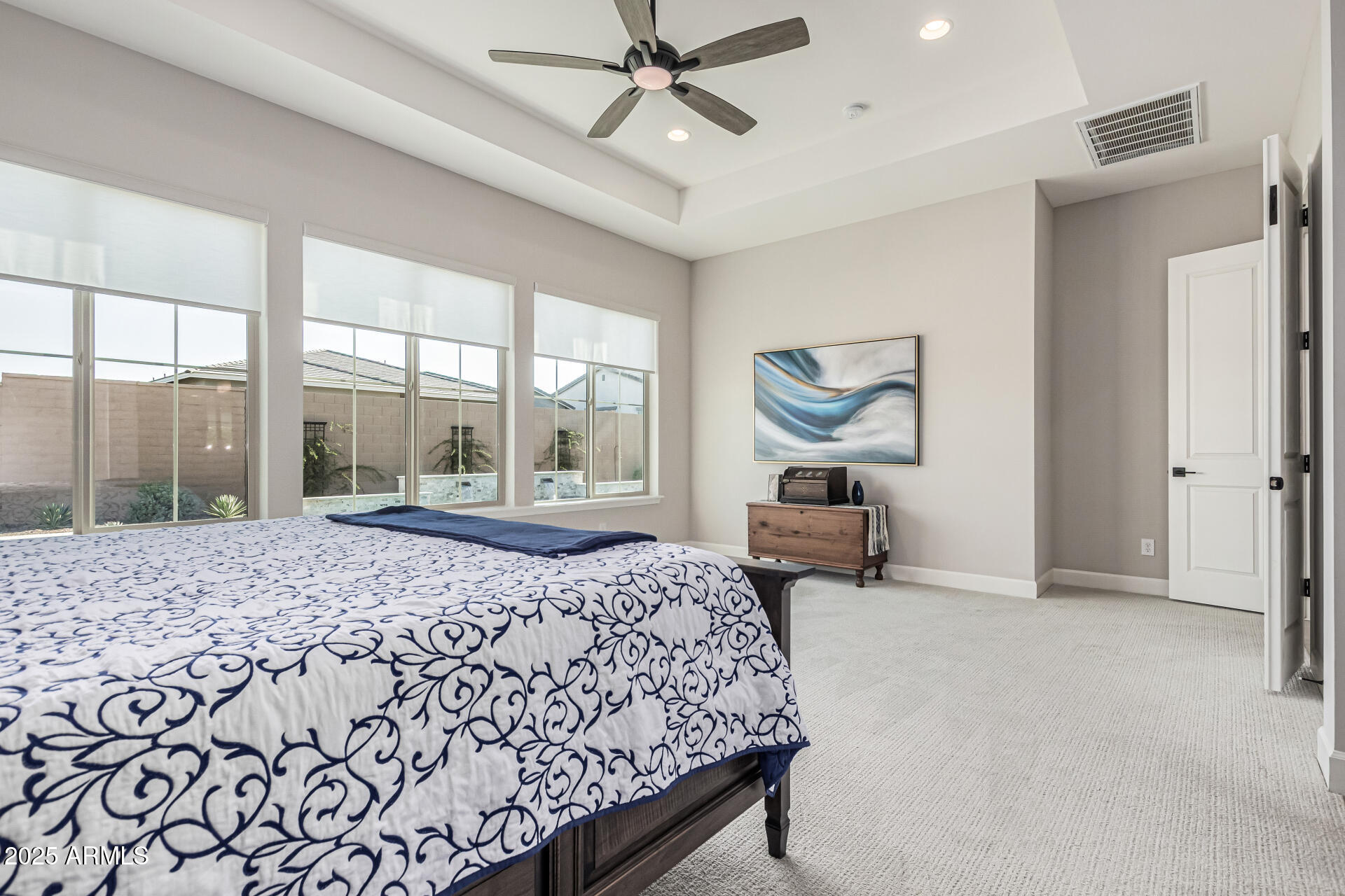 20709 West Rattler Road Buckeye, AZ 85396 - Photo 23 of 66 a bedroom with a large bed and a large window