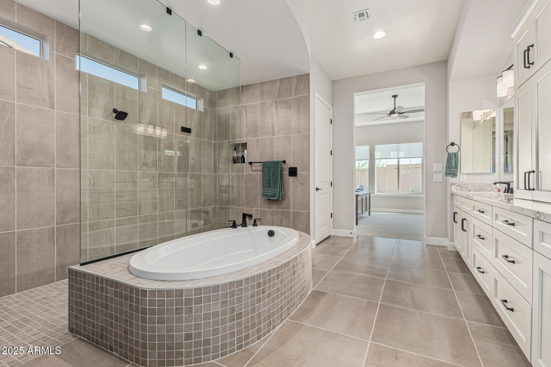 20709 West Rattler Road Buckeye, AZ 85396 - Photo 24 of 66 a bathroom with a tub a double vanity sink and mirror
