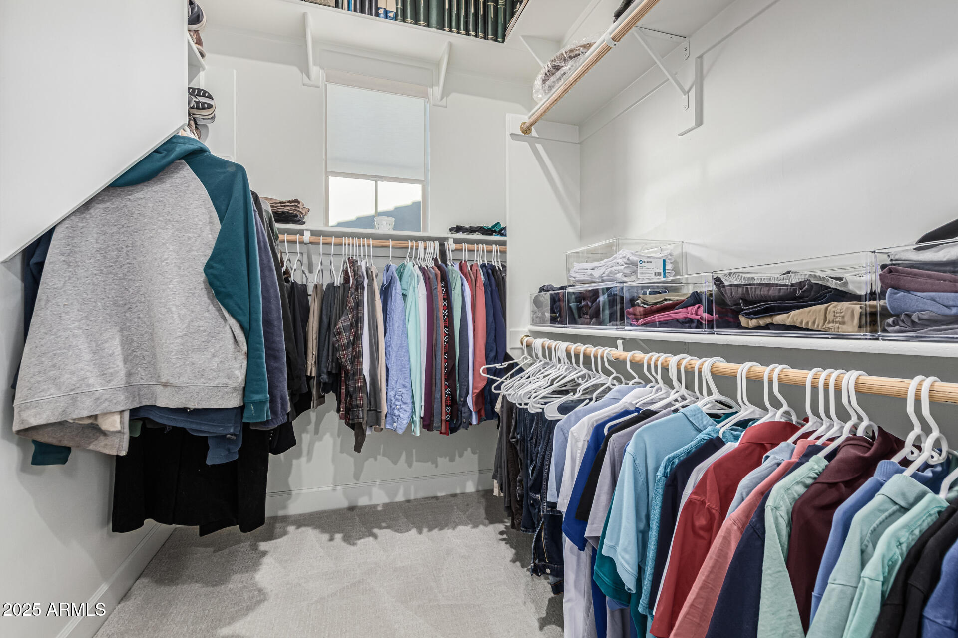 20709 West Rattler Road Buckeye, AZ 85396 - Photo 28 of 66 a view of walk in closet with clothes and shoes