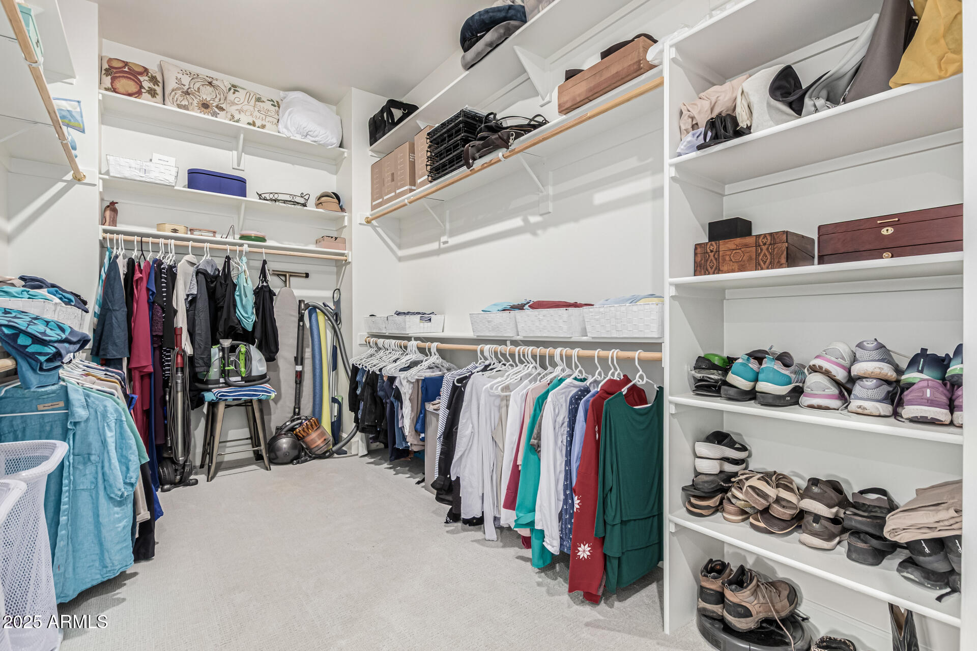 20709 West Rattler Road Buckeye, AZ 85396 - Photo 29 of 66 a view of walk in closet with clothes and shoes