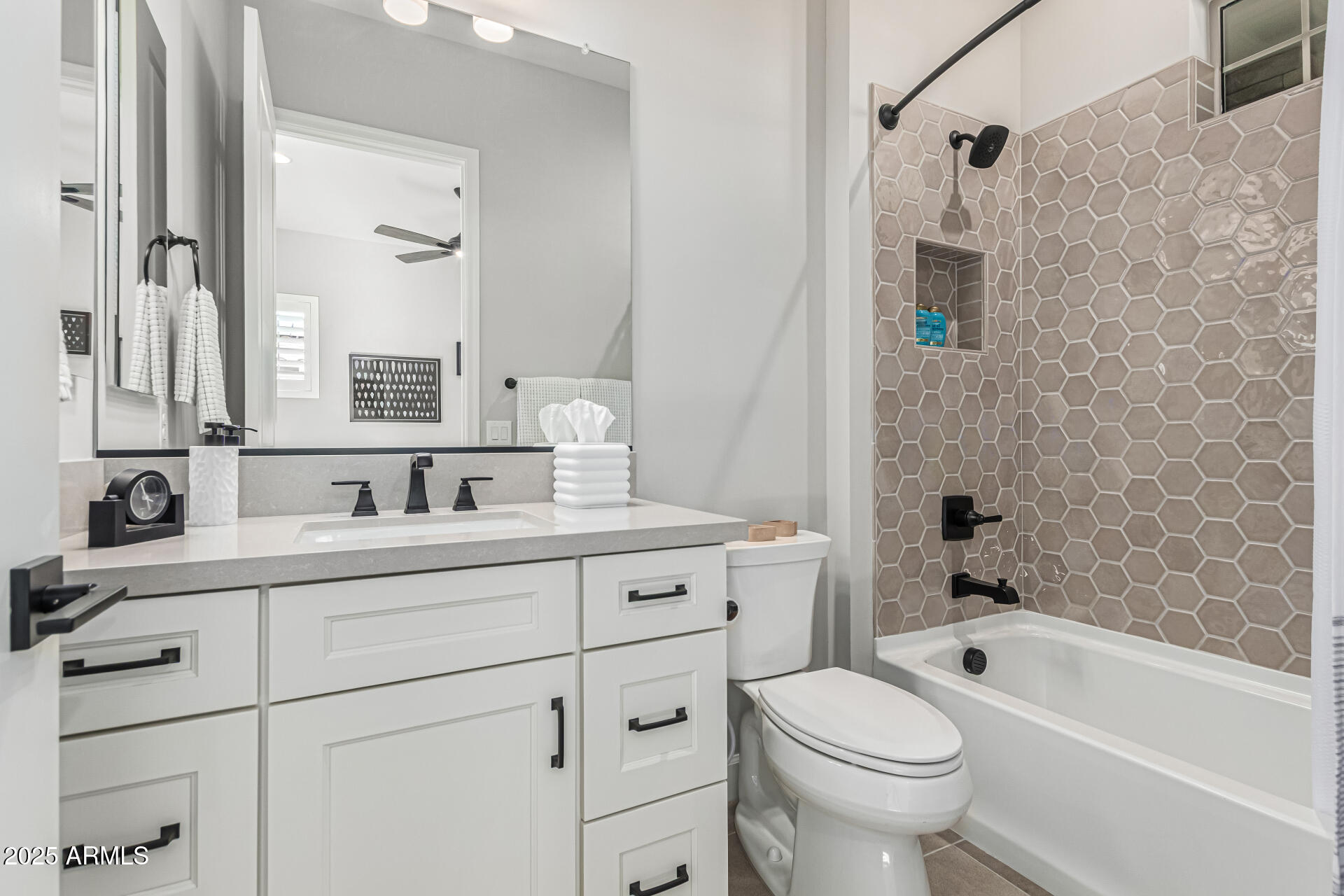 20709 West Rattler Road Buckeye, AZ 85396 - Photo 35 of 66 a bathroom with a granite countertop toilet a sink a mirror a bathtub and shower