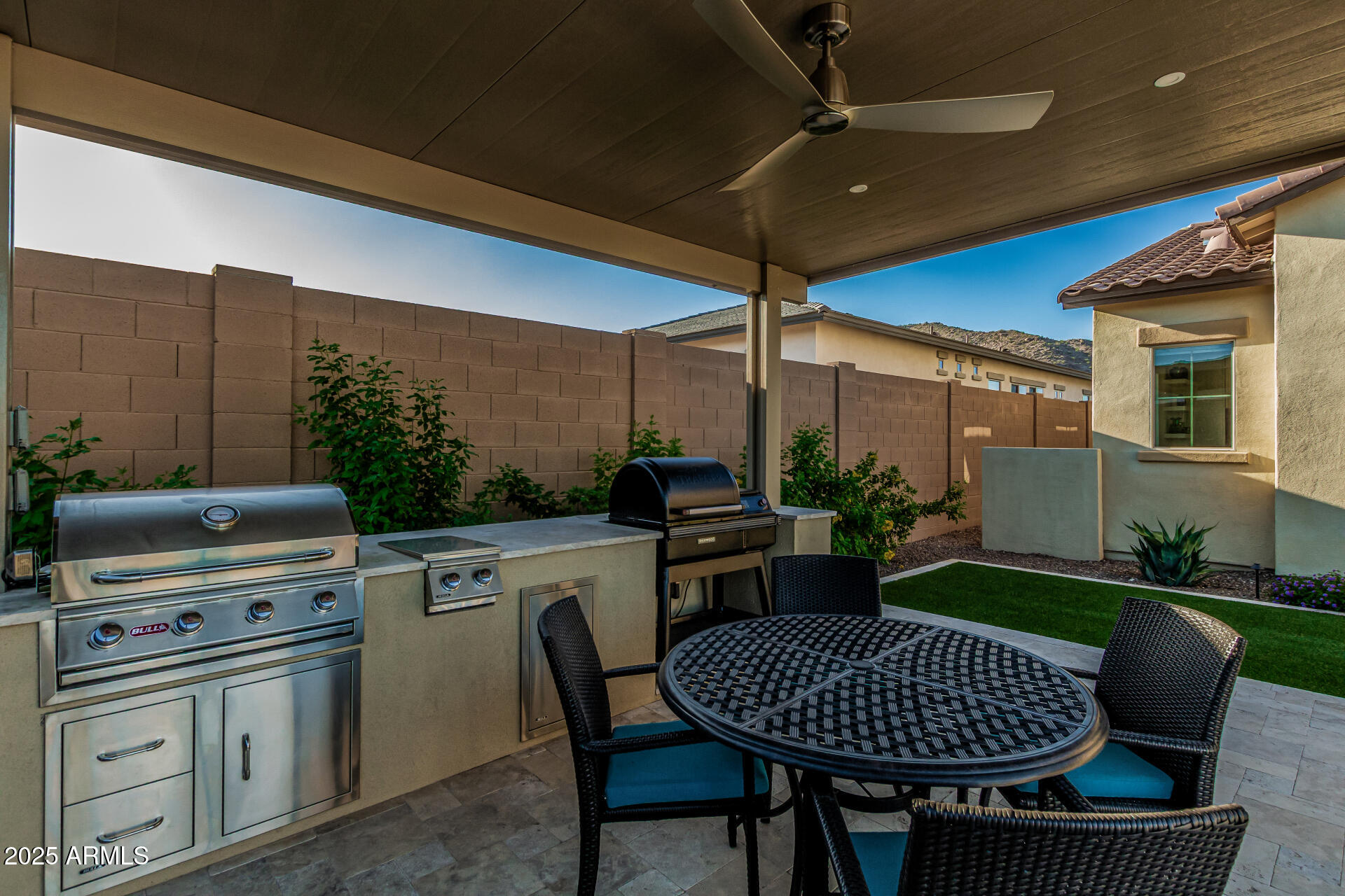 20709 West Rattler Road Buckeye, AZ 85396 - Photo 48 of 66 a kitchen with a table chairs and a barbeque