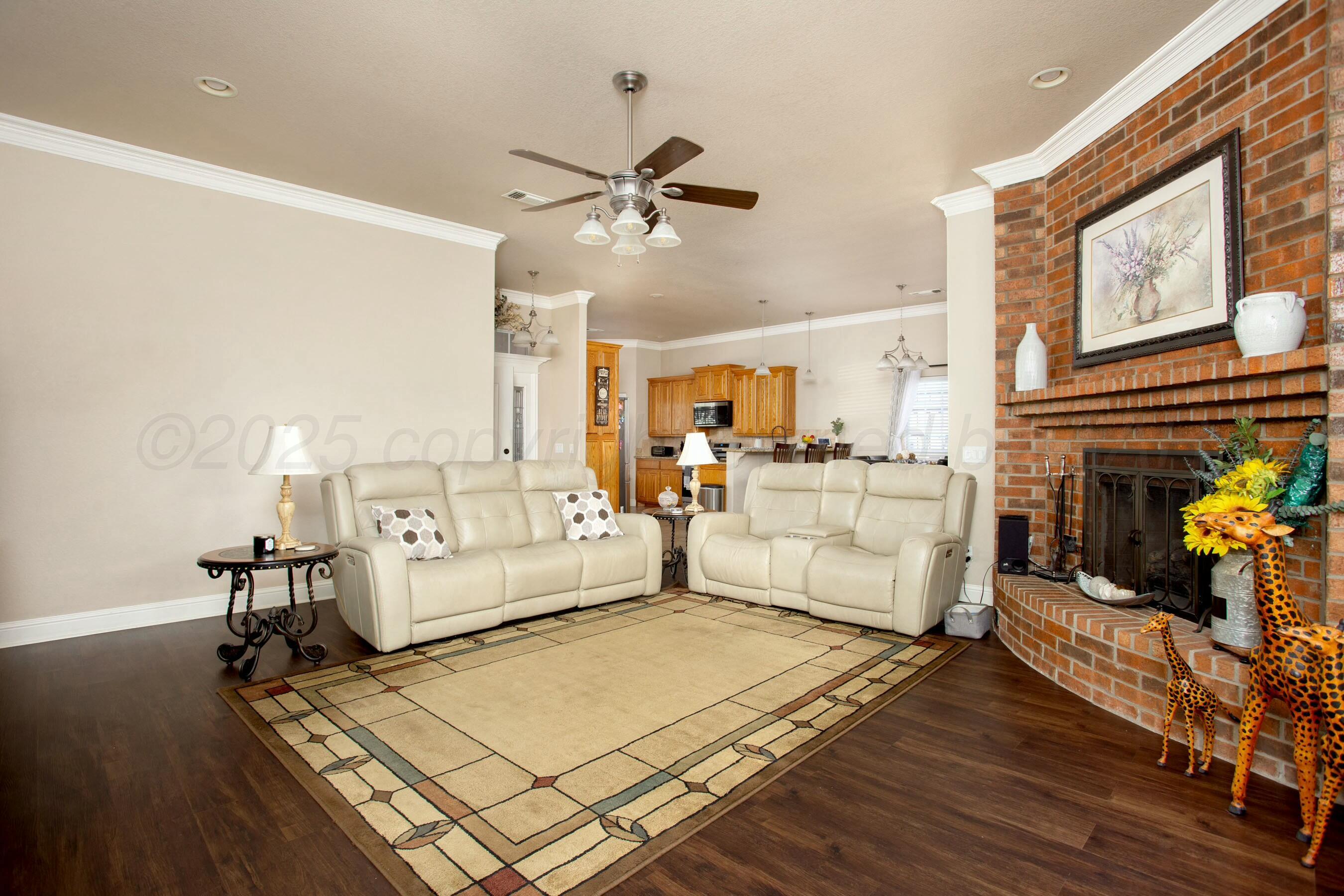 8103 El Paso Drive Amarillo, TX 79118 - Photo 11 of 40 a living room with furniture and a fireplace