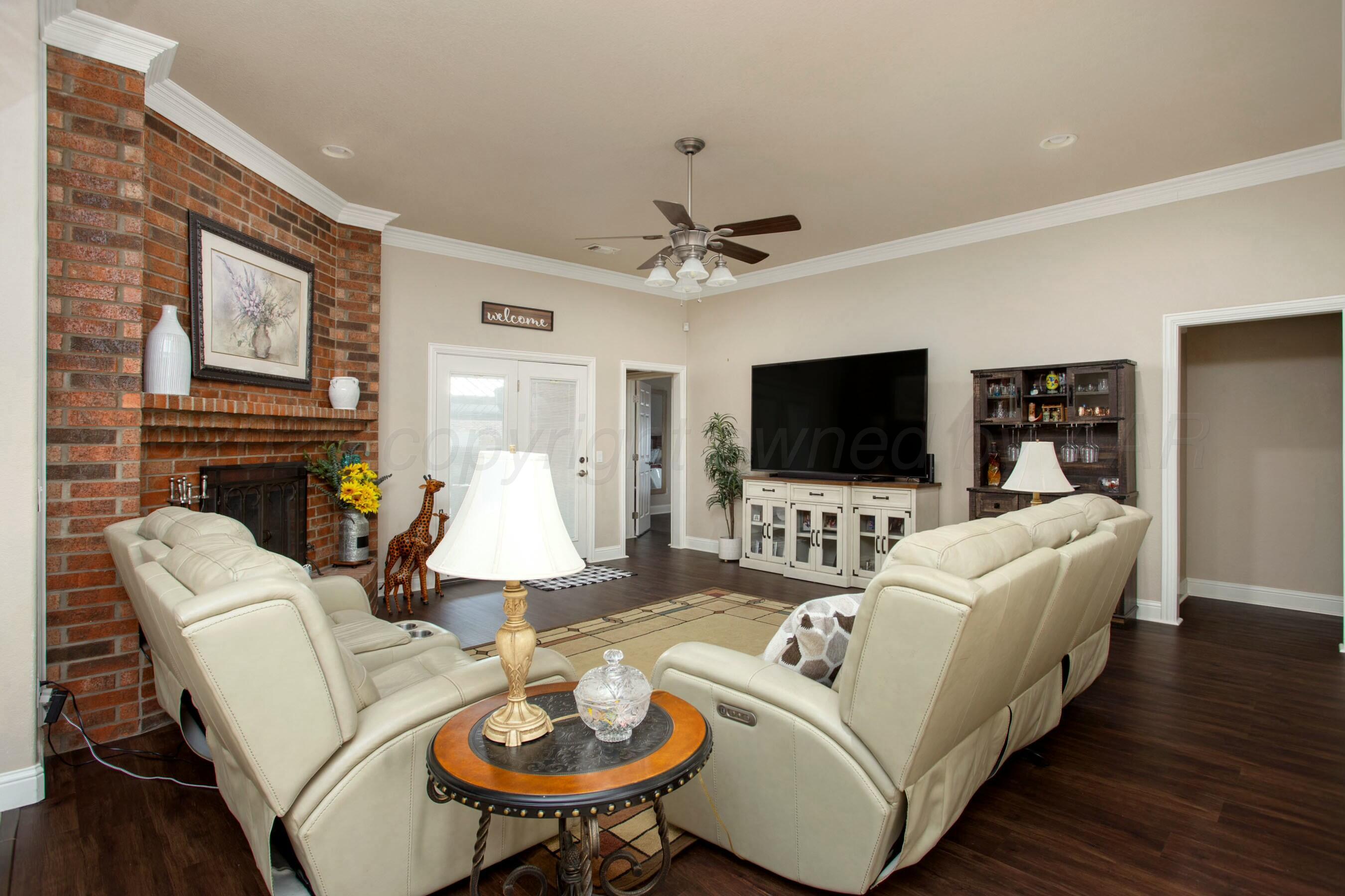 8103 El Paso Drive Amarillo, TX 79118 - Photo 13 of 40 a living room with furniture fireplace and a flat screen tv