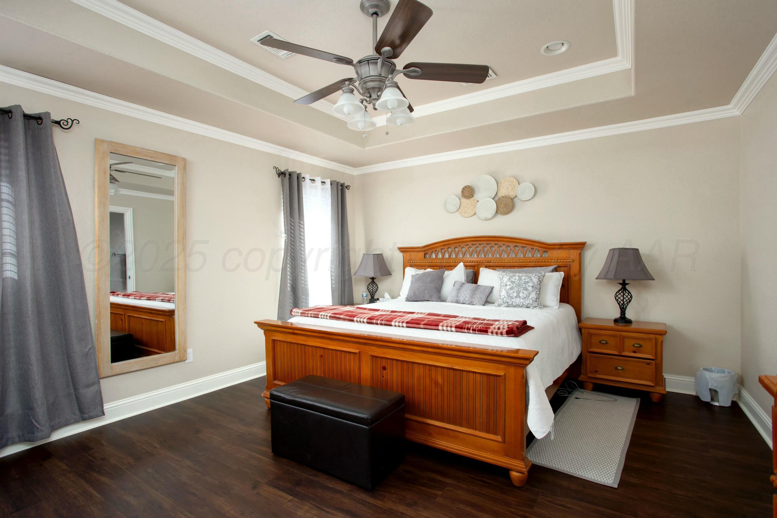 8103 El Paso Drive Amarillo, TX 79118 - Photo 14 of 40 a bedroom with a bed and a chandelier