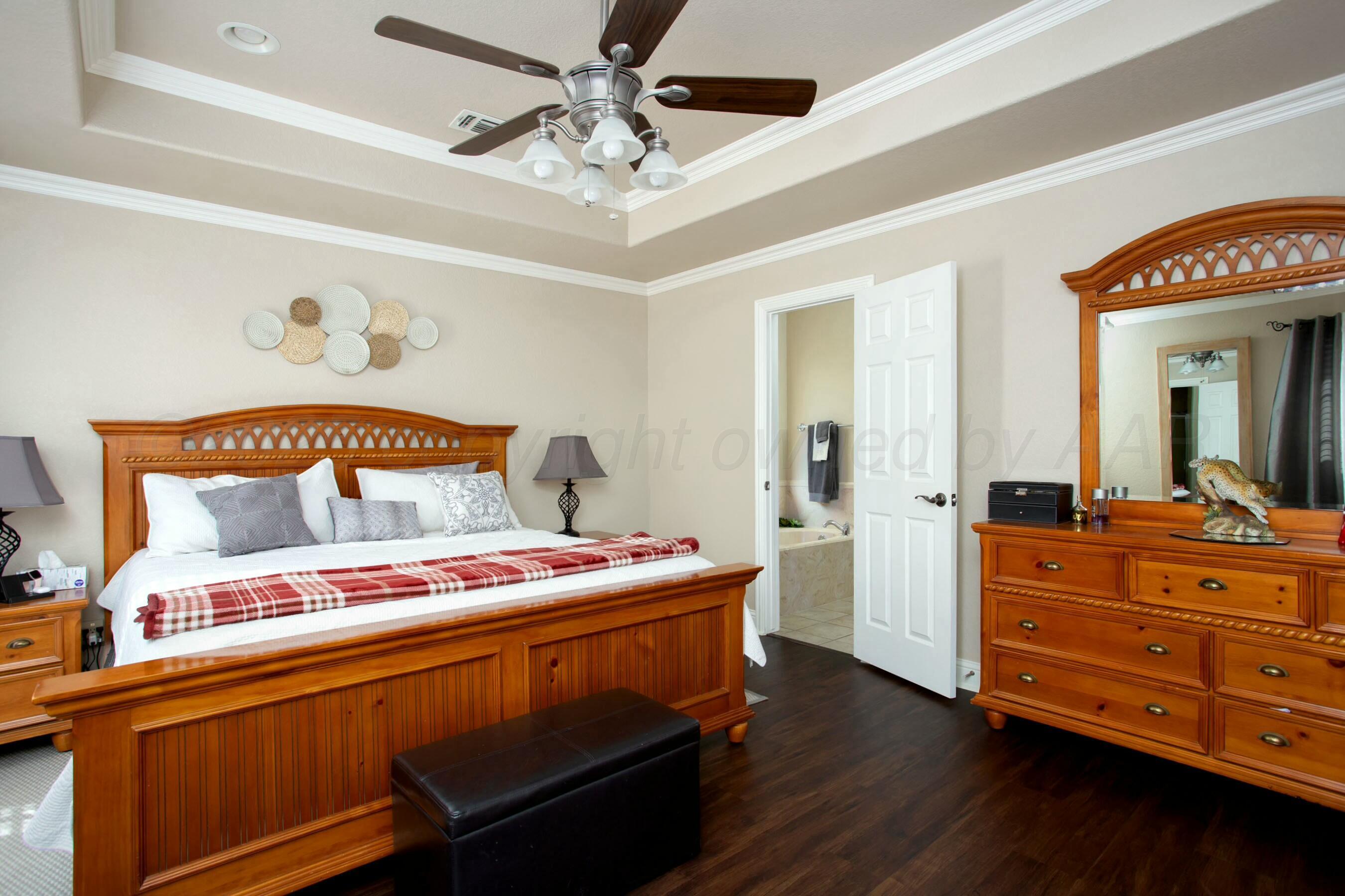 8103 El Paso Drive Amarillo, TX 79118 - Photo 15 of 40 a bedroom with a bed and a dresser in it