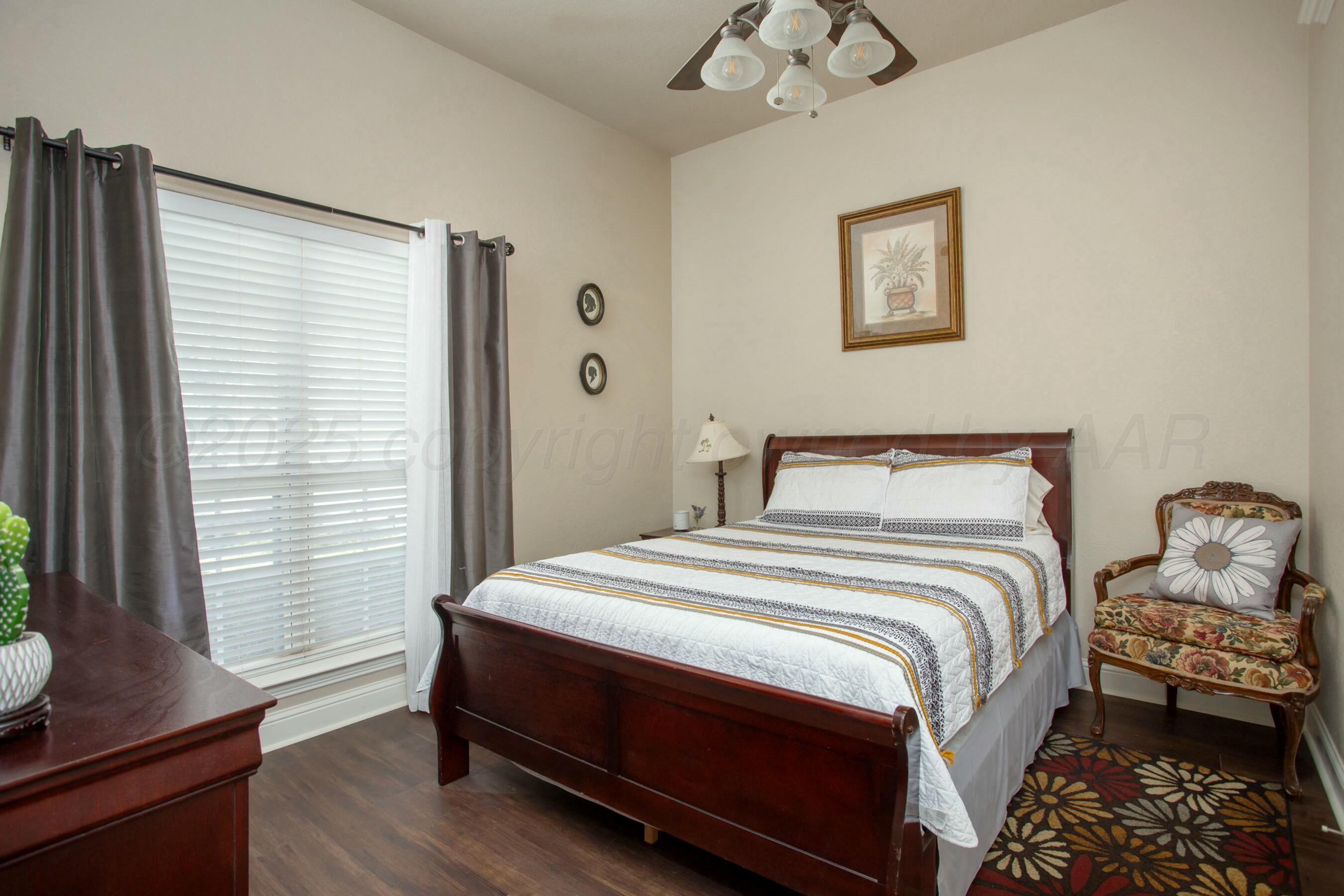 8103 El Paso Drive Amarillo, TX 79118 - Photo 18 of 40 a bedroom with a bed and a window