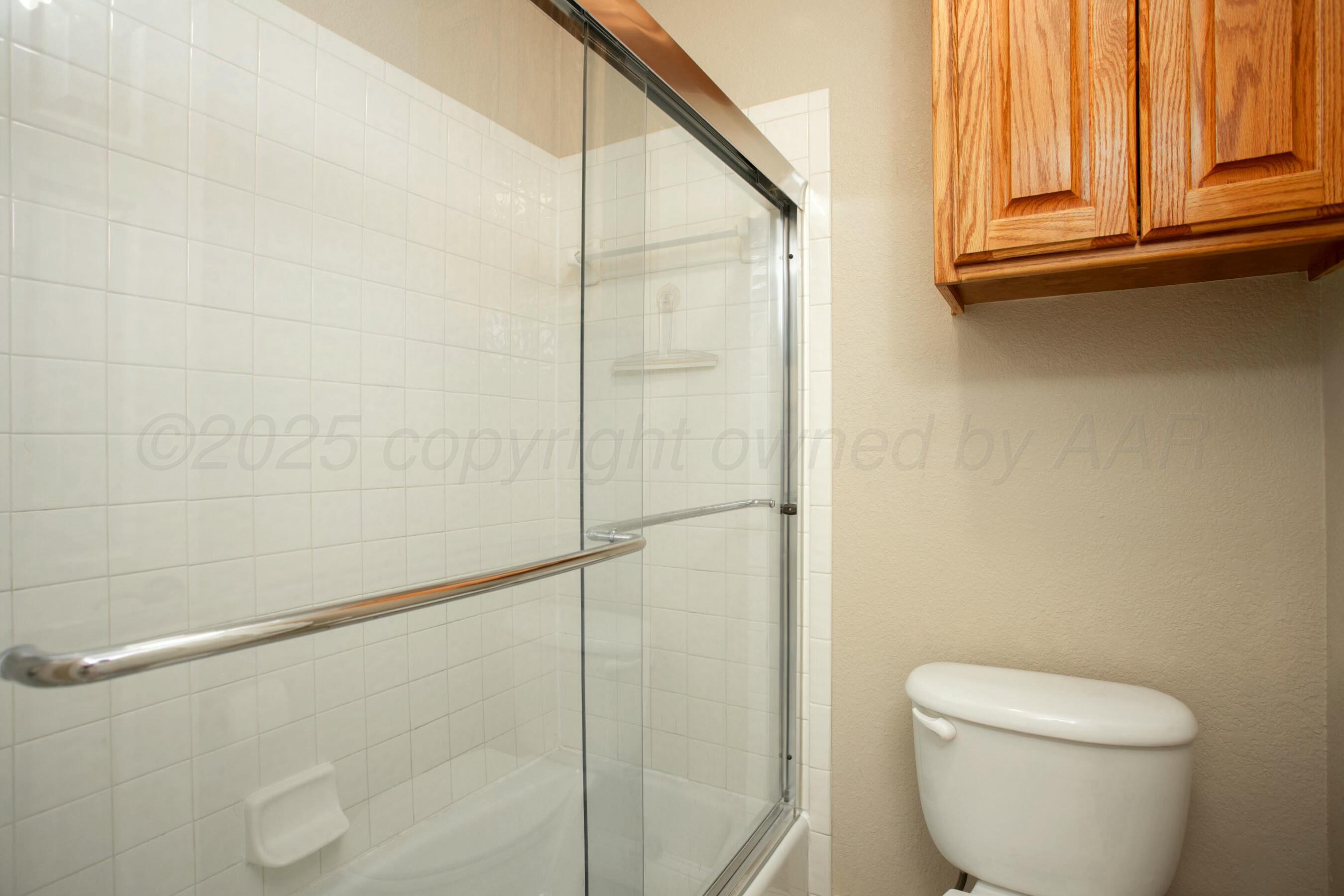 8103 El Paso Drive Amarillo, TX 79118 - Photo 21 of 40 a bathroom with a toilet and a shower