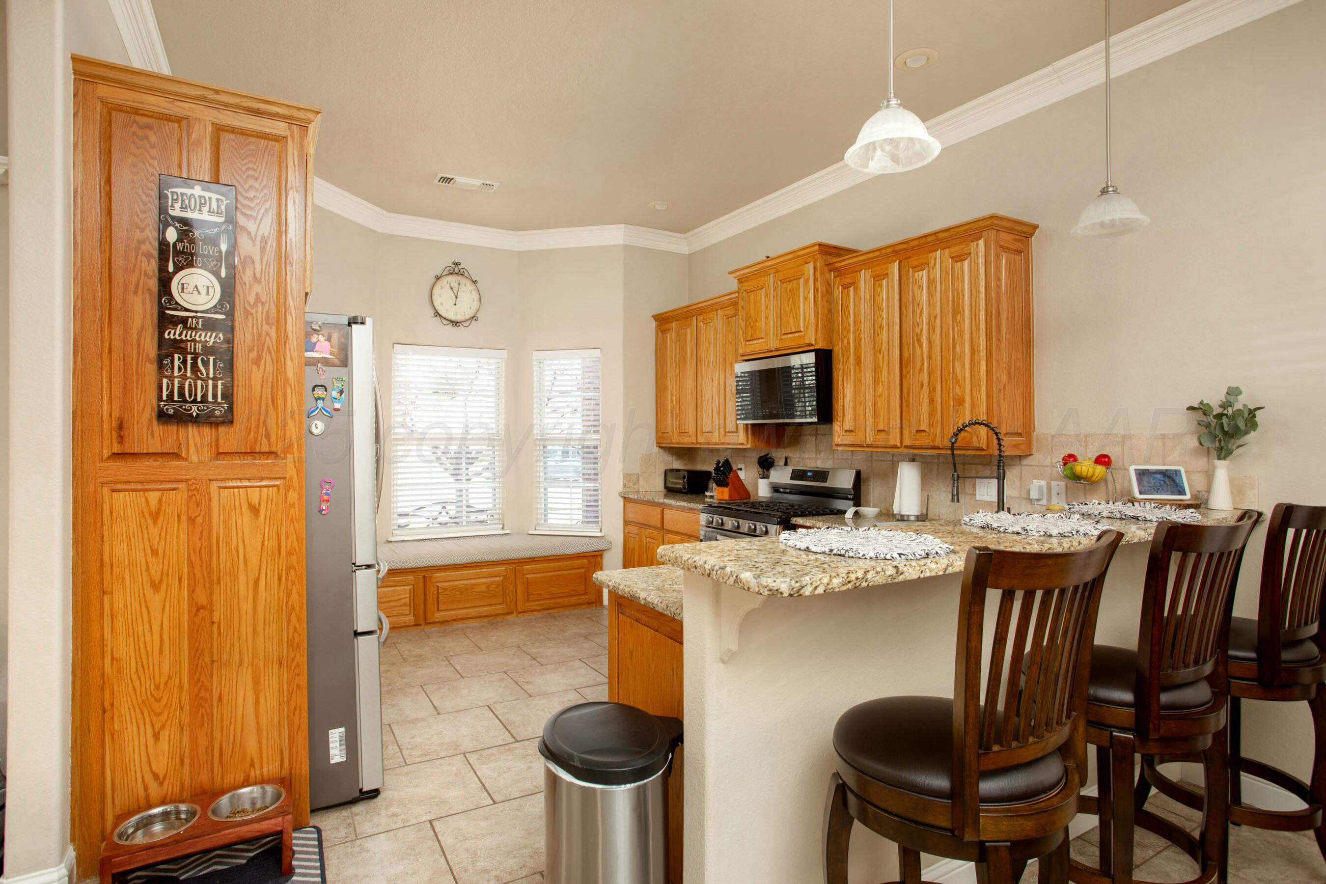 8103 El Paso Drive Amarillo, TX 79118 - Photo 4 of 40 a large kitchen with a table and chairs