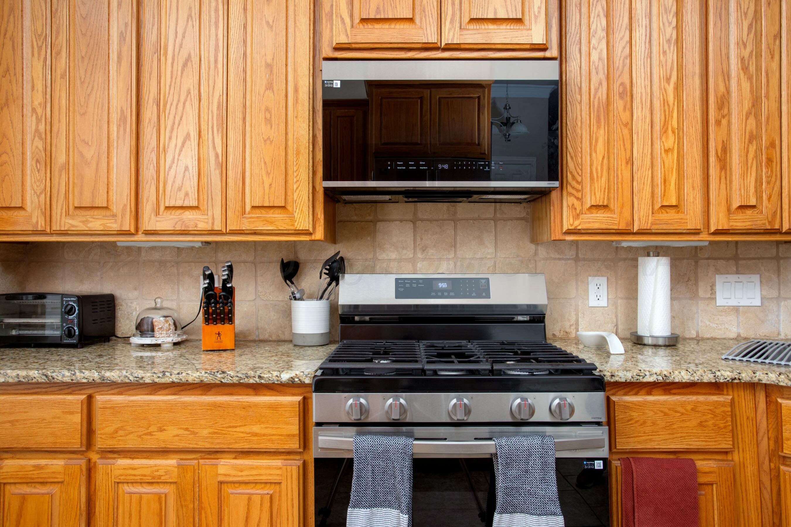 8103 El Paso Drive Amarillo, TX 79118 - Photo 5 of 40 a kitchen with granite countertop wood cabinets and stainless steel appliances