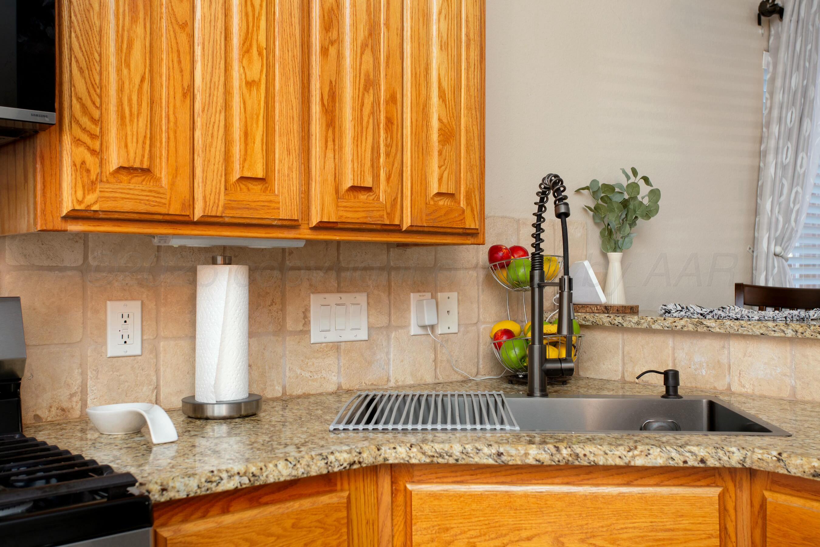 8103 El Paso Drive Amarillo, TX 79118 - Photo 8 of 40 a kitchen with granite countertop a sink and white cabinets