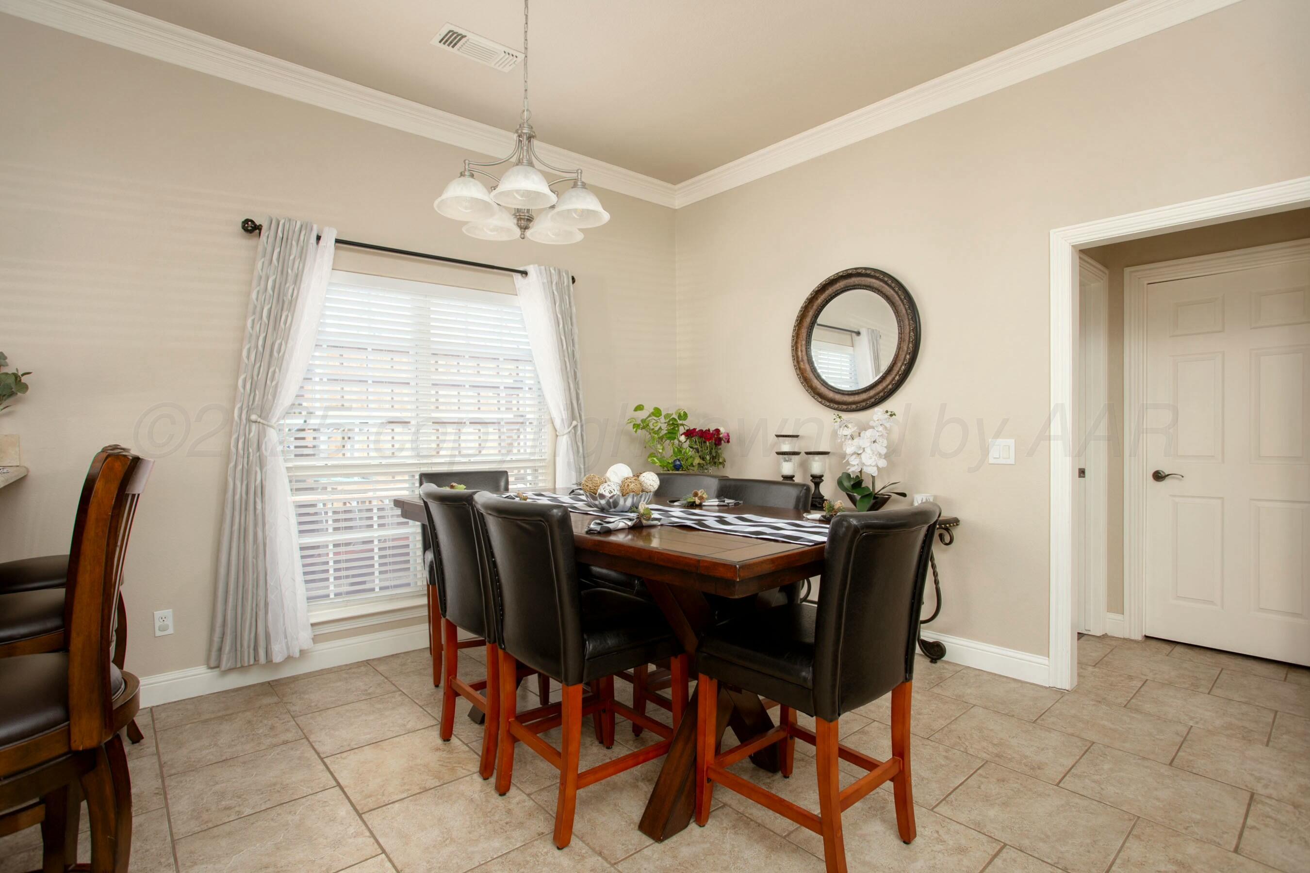 8103 El Paso Drive Amarillo, TX 79118 - Photo 9 of 40 a view of a dining room with furniture and a chandelier