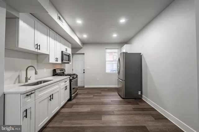 a kitchen with stainless steel appliances granite countertop a refrigerator sink and cabinets