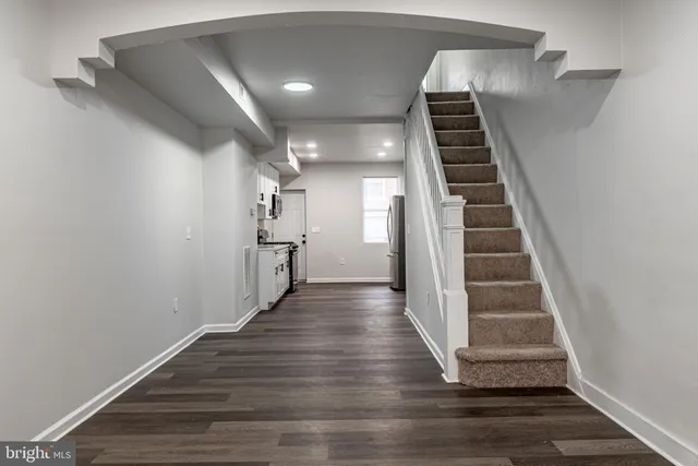 a view of entryway and hall with wooden floor