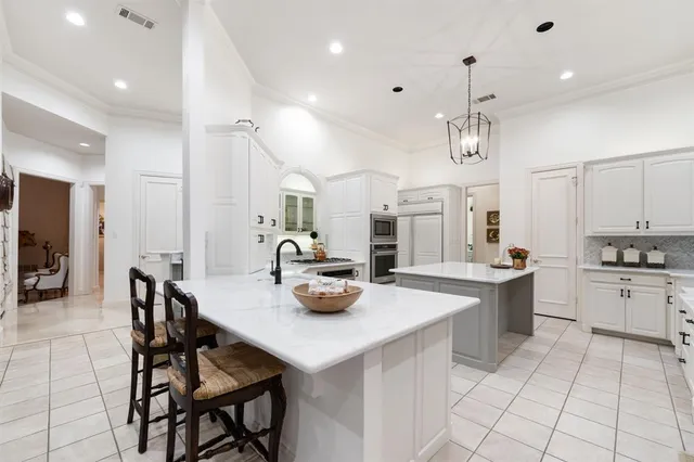 a kitchen with a sink a stove and chairs