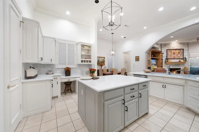 a kitchen with cabinets stainless steel appliances and a counter space