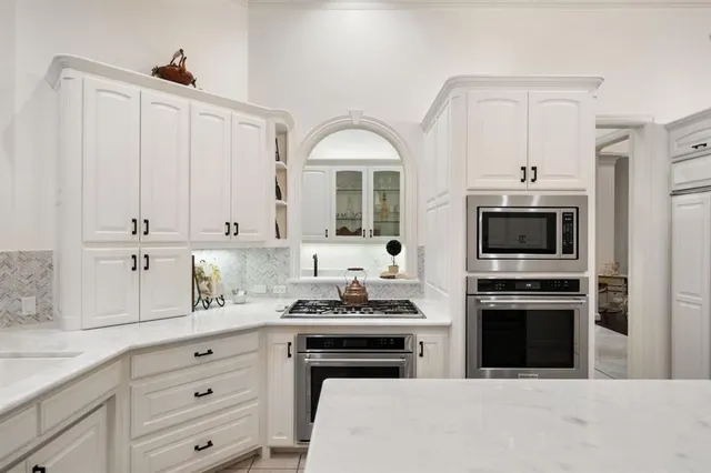 a kitchen with a sink and a stove top oven