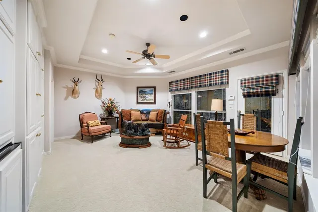 a spacious bedroom with a bed and a chandelier