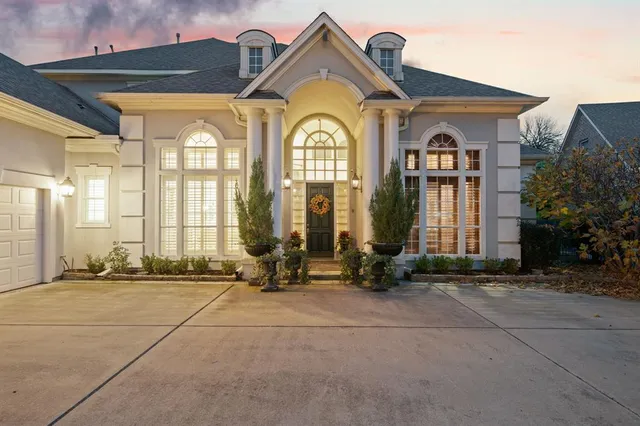 a view of a brick house with large windows