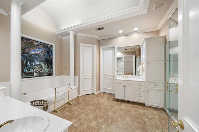 a bathroom with a bathtub a sink and a window