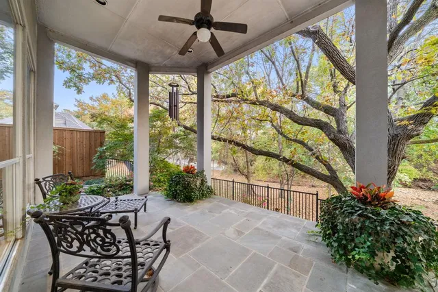 a view of a patio with table and chairs and potted plants